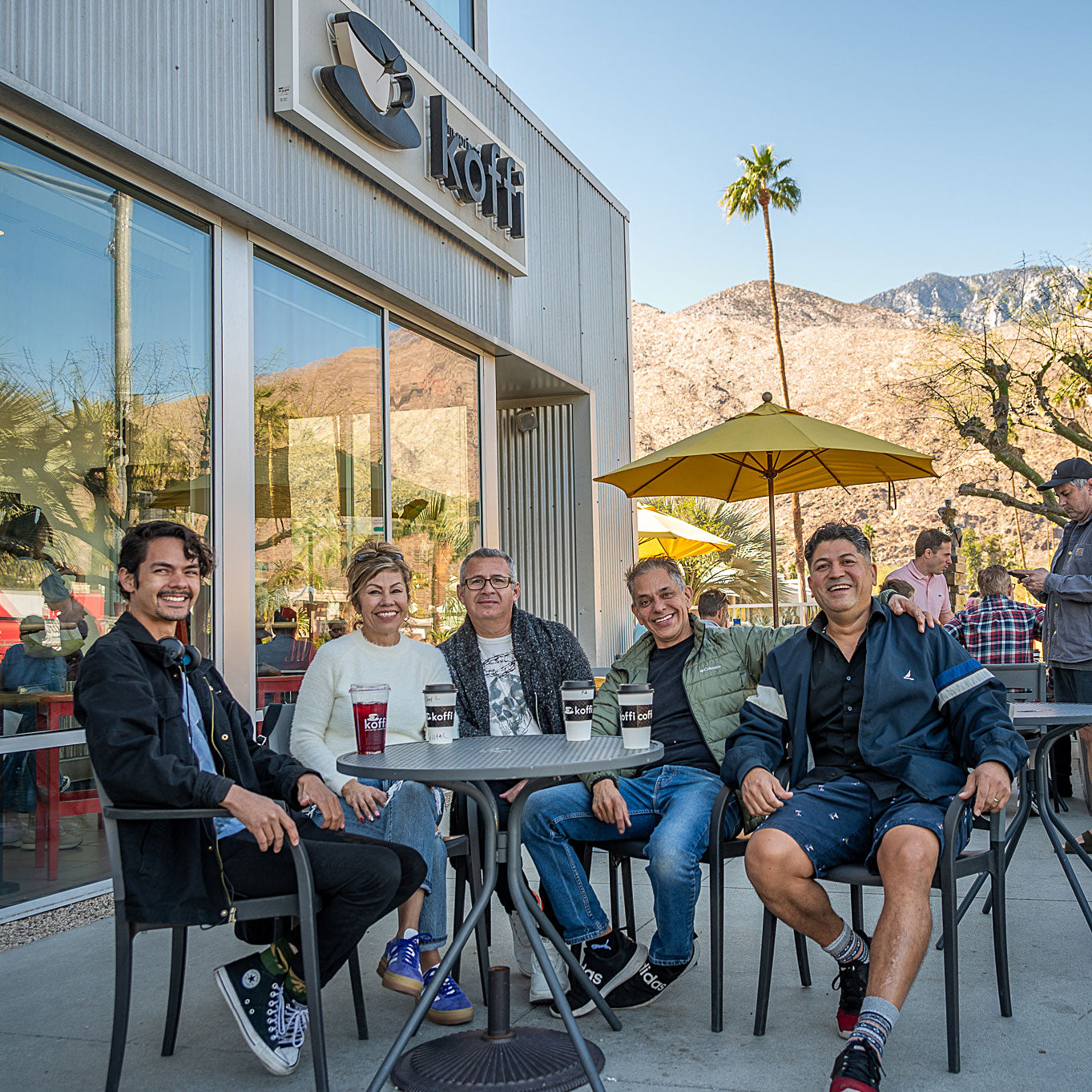 Friends having coffee on a Koffi Coffee patio