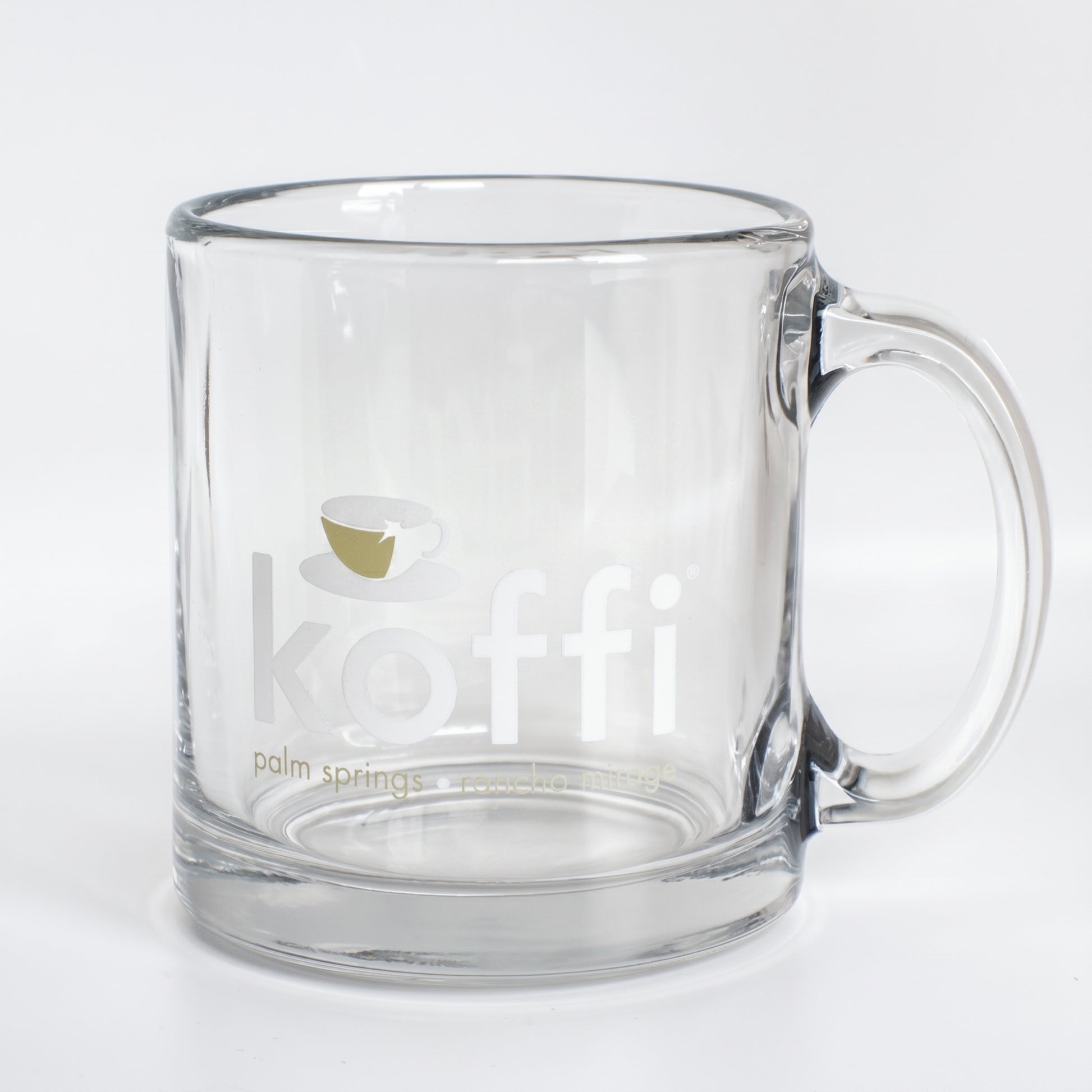 Clear glass mug with 'koffi' branding on a white background